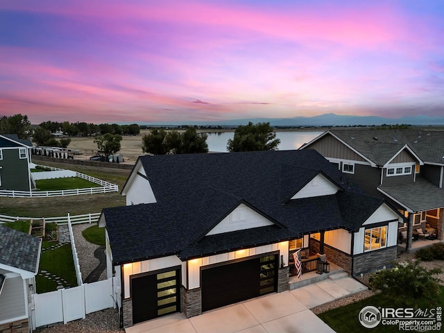 view of front of house featuring a water view and a garage