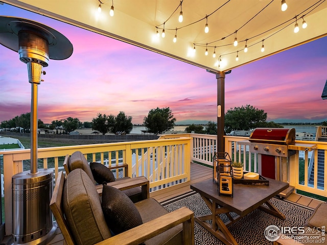 deck at dusk with area for grilling