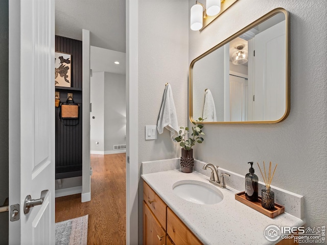 bathroom with vanity and hardwood / wood-style flooring