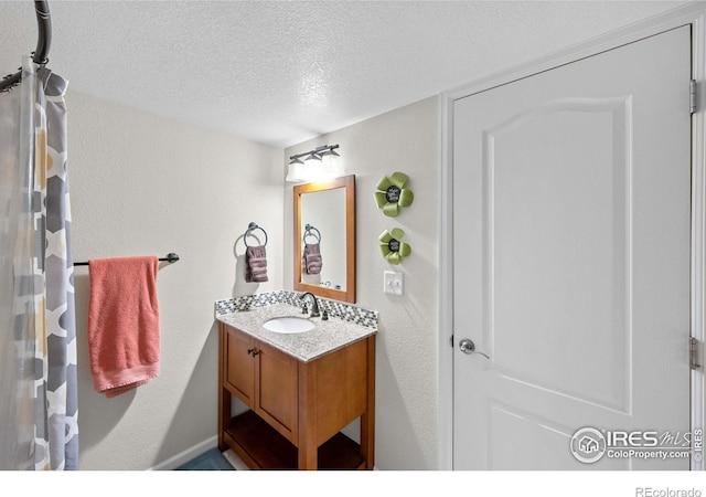 bathroom with vanity and a textured ceiling