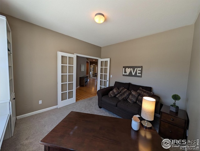 carpeted living room featuring french doors