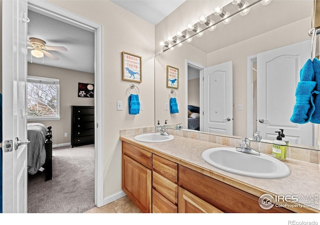 bathroom with ceiling fan, tile patterned flooring, and vanity