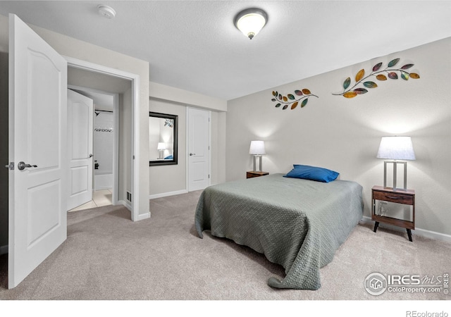 bedroom featuring light carpet, a closet, and a textured ceiling