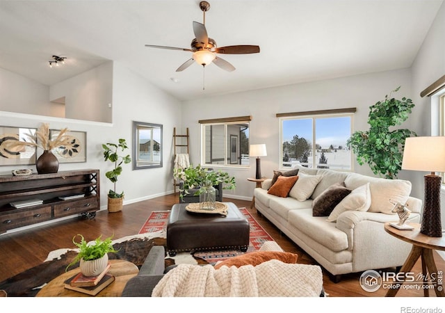 living room featuring vaulted ceiling, ceiling fan, and dark hardwood / wood-style floors