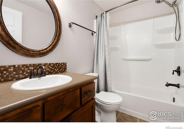 full bathroom with vanity, toilet, shower / tub combo, and tasteful backsplash