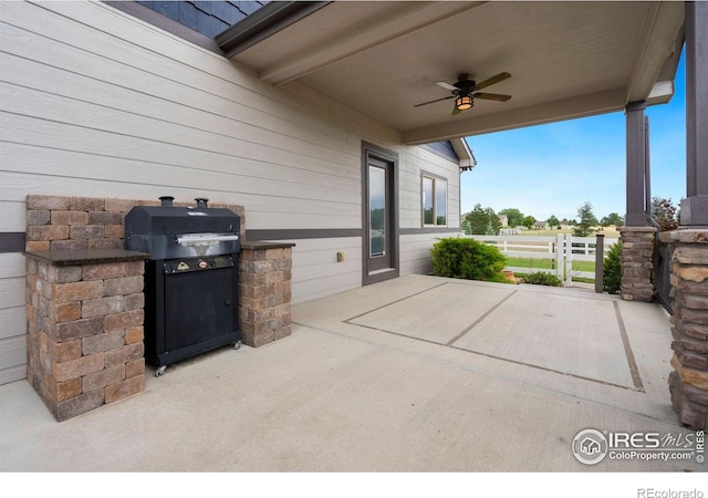 view of patio with ceiling fan and area for grilling