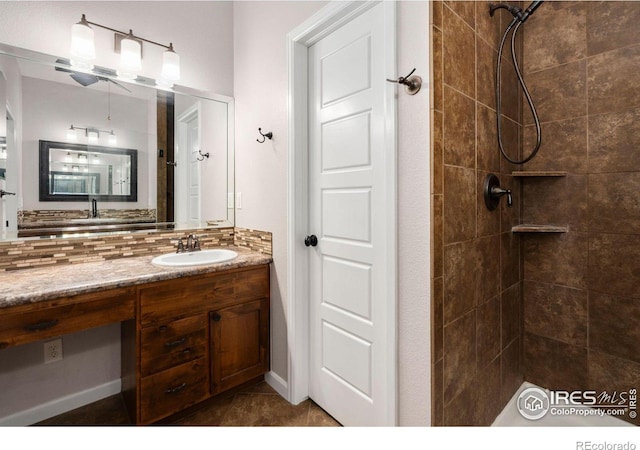 bathroom with a tile shower, tasteful backsplash, and vanity