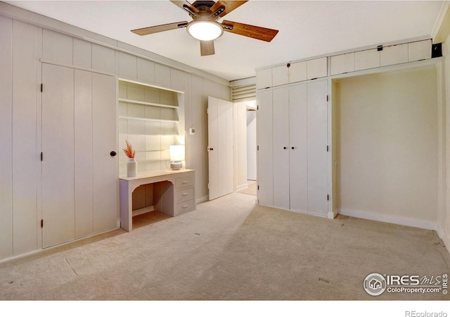 unfurnished bedroom featuring light carpet and ceiling fan