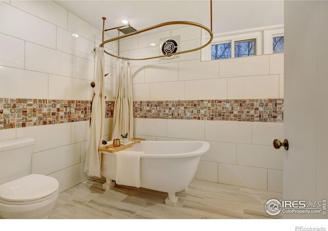 bathroom featuring independent shower and bath, tile walls, and toilet