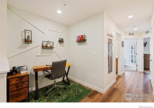 home office with hardwood / wood-style flooring