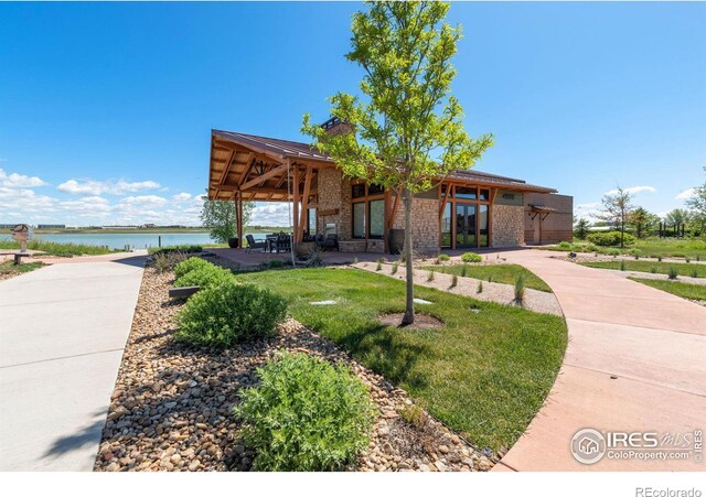 exterior space with a front yard and a water view