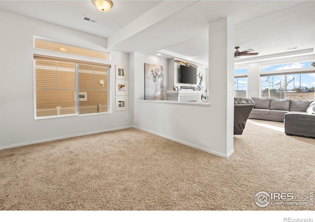 carpeted living room featuring ceiling fan