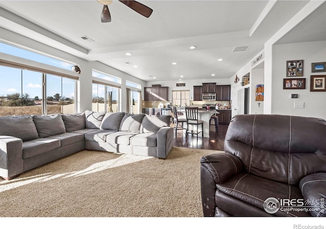 living room featuring hardwood / wood-style flooring and ceiling fan