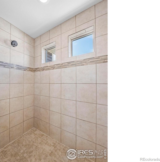 bathroom featuring tiled shower