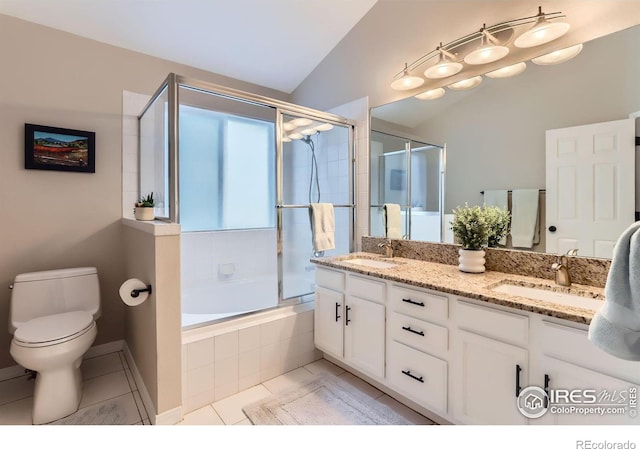 full bathroom featuring tile patterned floors, lofted ceiling, combined bath / shower with glass door, toilet, and vanity