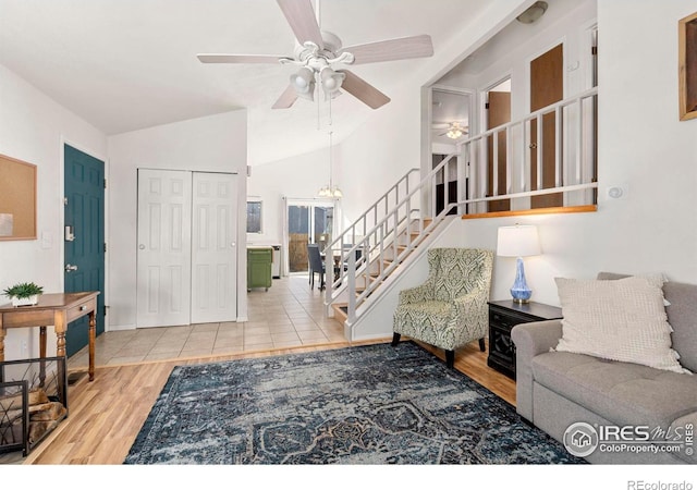 living room featuring wood-type flooring, vaulted ceiling, and ceiling fan