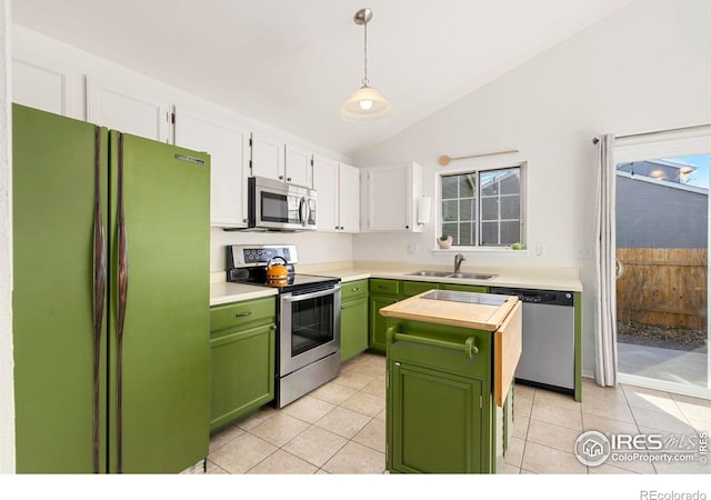 kitchen featuring pendant lighting, lofted ceiling, green cabinetry, appliances with stainless steel finishes, and white cabinetry