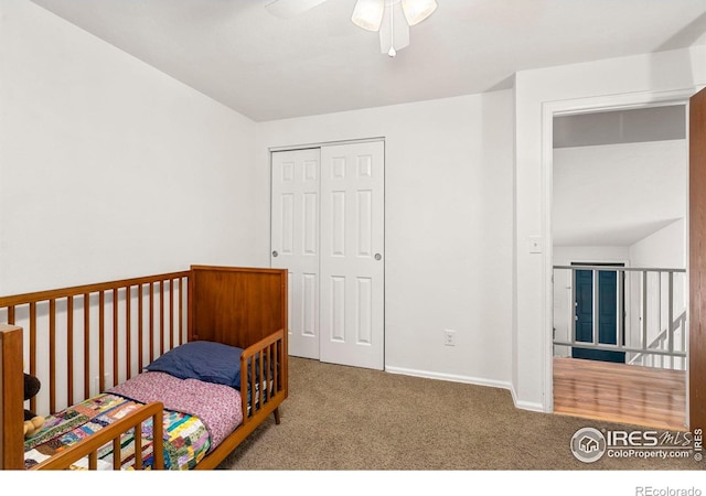 carpeted bedroom with ceiling fan and a closet