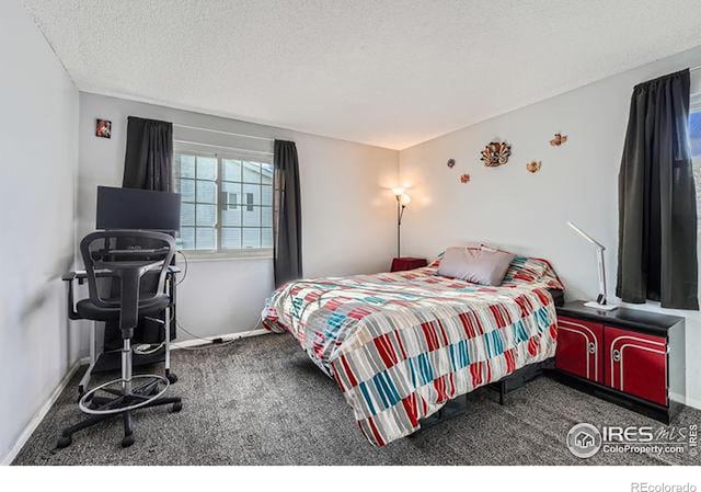 carpeted bedroom with a textured ceiling