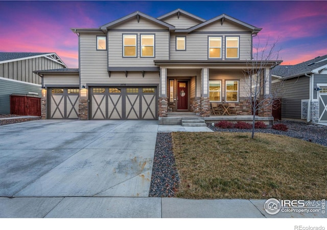 view of front of house featuring a yard and a garage