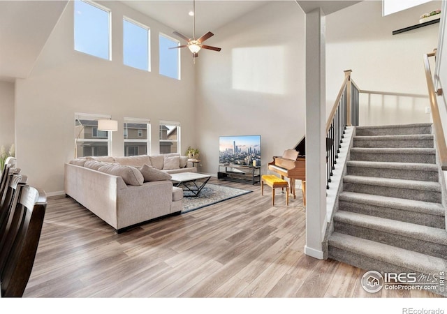 living room featuring hardwood / wood-style flooring and ceiling fan