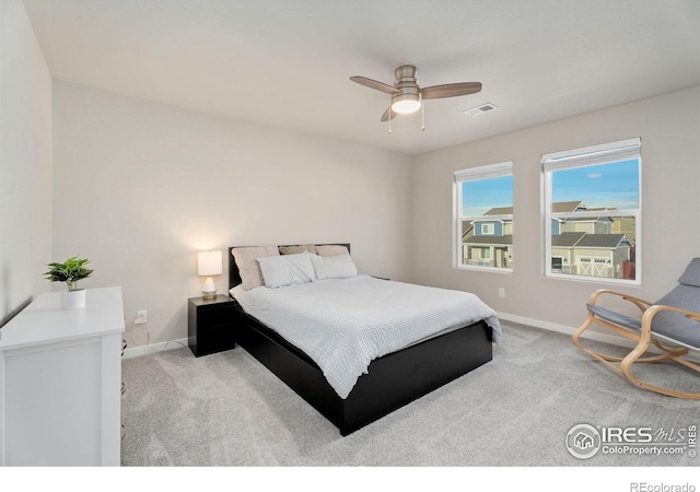 bedroom with ceiling fan and light colored carpet