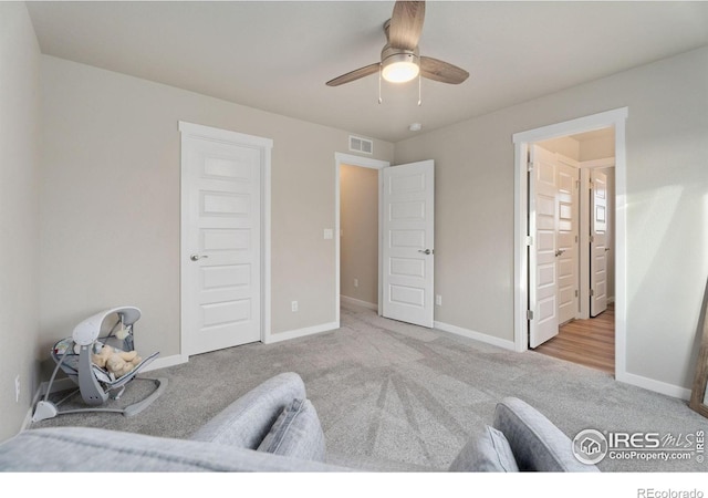 sitting room featuring ceiling fan and light carpet