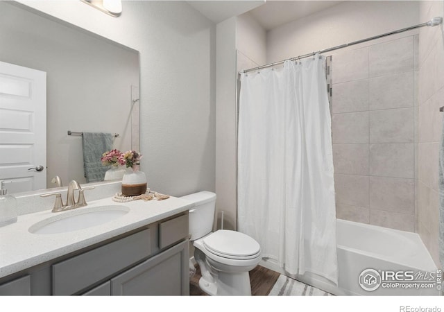 full bathroom featuring toilet, vanity, shower / bathtub combination with curtain, and hardwood / wood-style floors