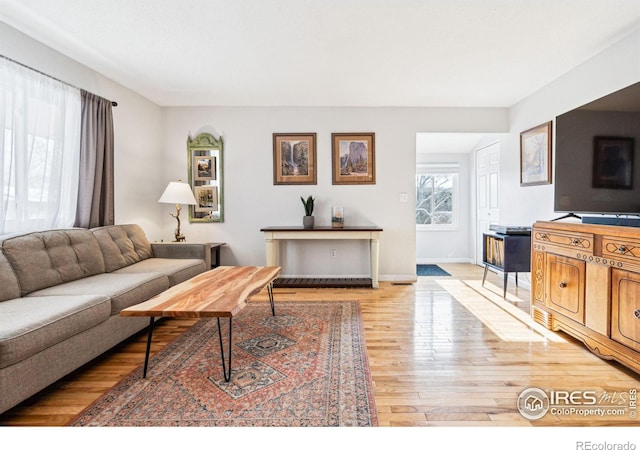 living room with light hardwood / wood-style flooring