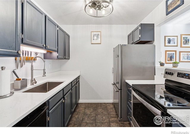 kitchen featuring appliances with stainless steel finishes, gray cabinets, and sink