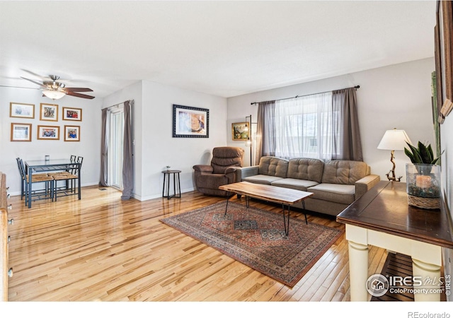 living room with hardwood / wood-style flooring and ceiling fan