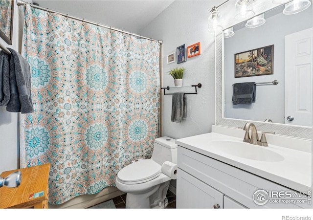 bathroom with vanity, a shower with shower curtain, and toilet