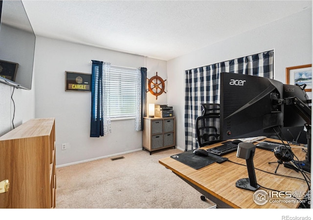 office area with light carpet and a textured ceiling