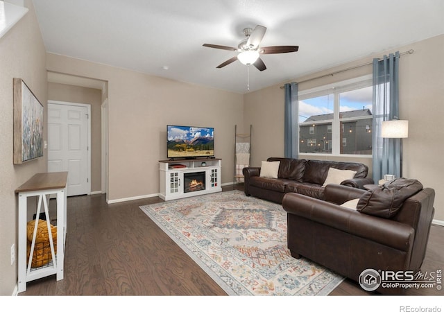 living room with dark hardwood / wood-style floors and ceiling fan