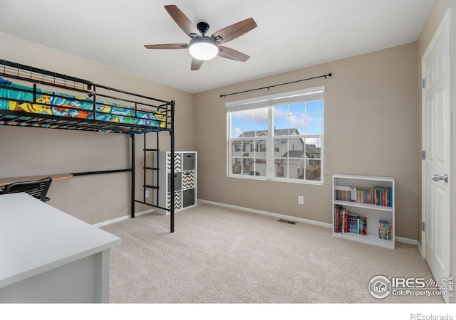 bedroom with ceiling fan and light carpet