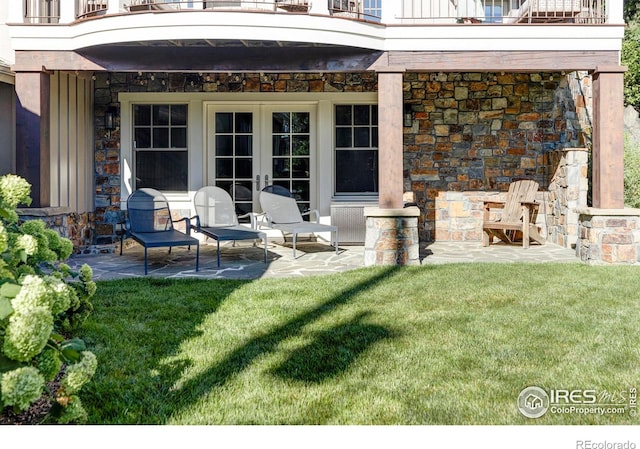 view of patio with a balcony and french doors