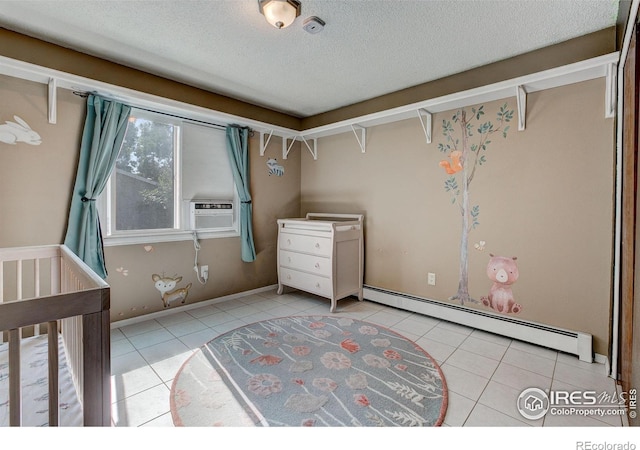 unfurnished bedroom featuring a baseboard radiator, cooling unit, a textured ceiling, light tile patterned flooring, and a crib