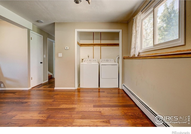 washroom with hardwood / wood-style floors, independent washer and dryer, and baseboard heating