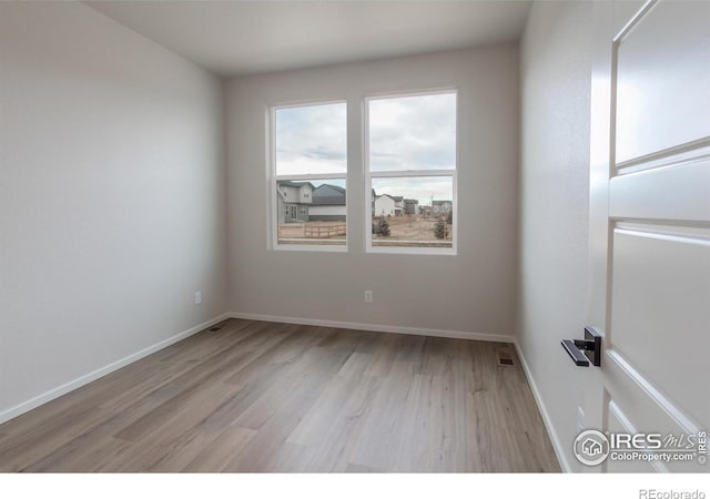 spare room featuring light hardwood / wood-style flooring