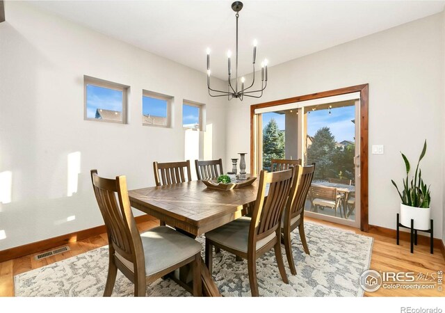 dining room with a notable chandelier and light hardwood / wood-style floors