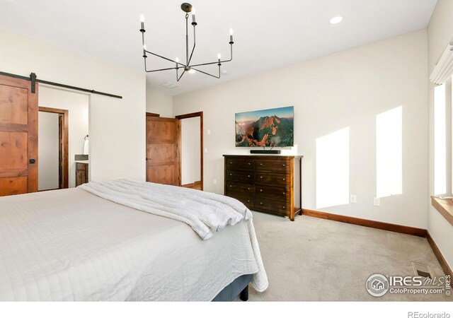 bedroom with multiple windows, light carpet, a notable chandelier, and a barn door