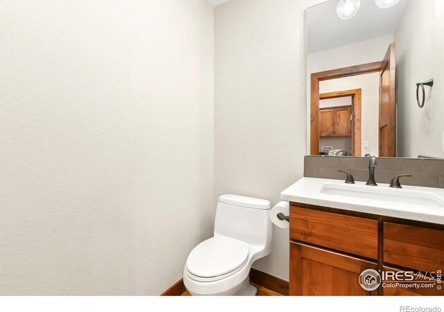 bathroom featuring toilet and vanity