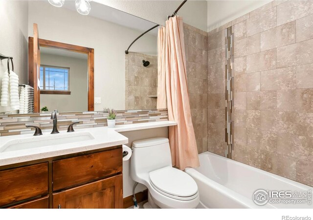 full bathroom with toilet, backsplash, shower / bathtub combination with curtain, and vanity