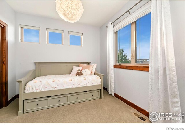 bedroom featuring light carpet