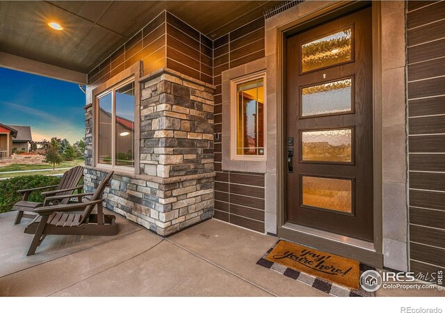 exterior entry at dusk featuring covered porch