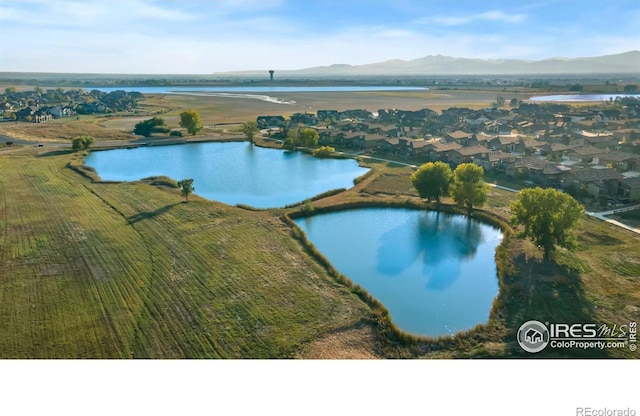 drone / aerial view with a water and mountain view