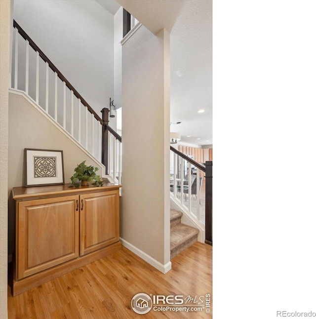 stairway featuring wood-type flooring