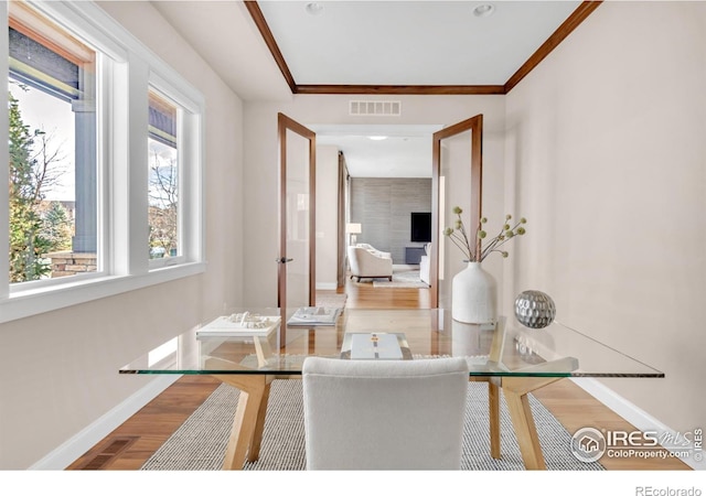 living room featuring hardwood / wood-style floors and crown molding