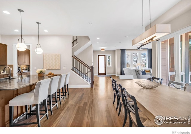 dining room with hardwood / wood-style floors and sink