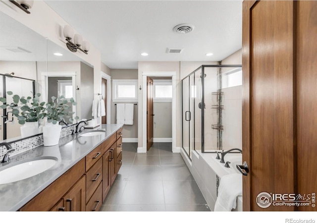 bathroom with vanity and independent shower and bath